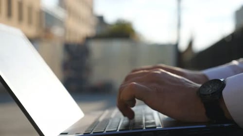 Close Up to Male Hands of Successful Businessman Typing Text on Notebook Keyboard Outdoor Arms of