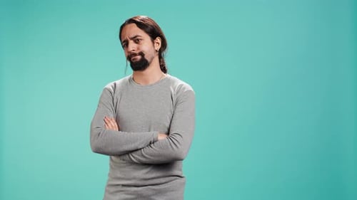 Man with Crossed Arms Making Silly Faces