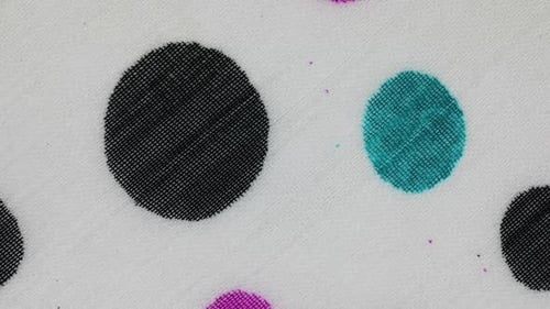 White Fabric With Colorful Polka Dots Design. - Closeup Shot