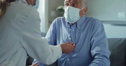 Doctor Checks Senior Patient with Stethoscope and Mask