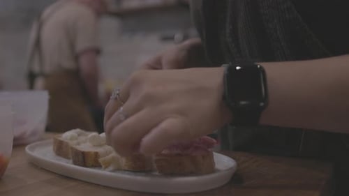Chef Preparing Sandwiches on Wooden Table