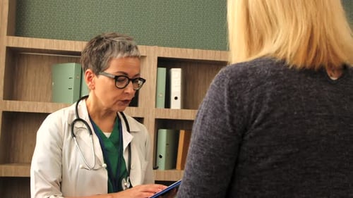 Doctor Consults With Patient in Medical Office