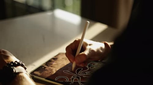 Hand Using Stylus on a Tablet Device