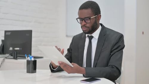 Businessman Using Tablet at Clean White Desk