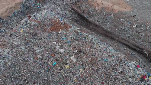 Aerial shot ascending to reveal a large Landfill site, ecological problem