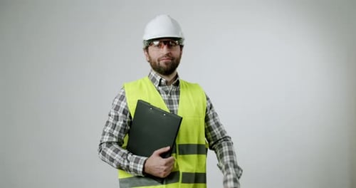 Smiling Man in Hard Hat Gives Thumbs Up