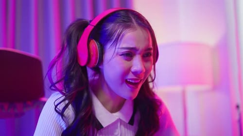 Young Woman Plays Video Game in Neon-Lit Room