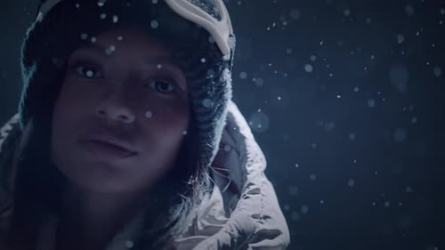 Woman Outdoors in Snowy Winter Weather Puts on Goggles