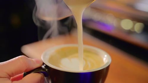 Milk Being Poured into Coffee for Latte Art