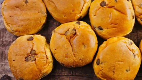 Many Briochettes Arranged on a Wooden Background