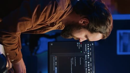 IT Specialist Sitting at Computer Desk Working on Desktop PC