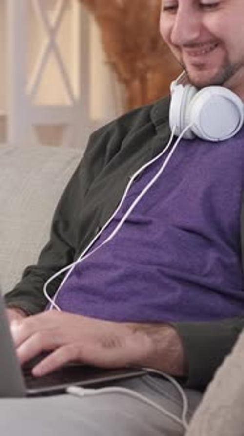Young Adult Using Laptop Computer at Home