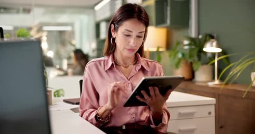 Elegant Woman Uses Tablet at Her Office Desk