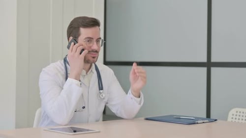 Doctor Talking on Phone in Clinic