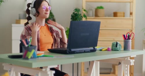 Woman Studying and Using Laptop at Desk