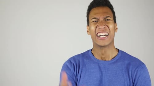 Angry Young Adult Man Yelling Indoors