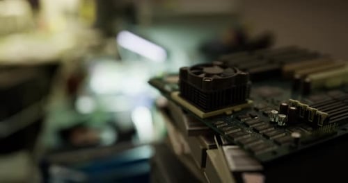 Close Up View of a Circuit Board with Components in a Dimly Lit Workshop