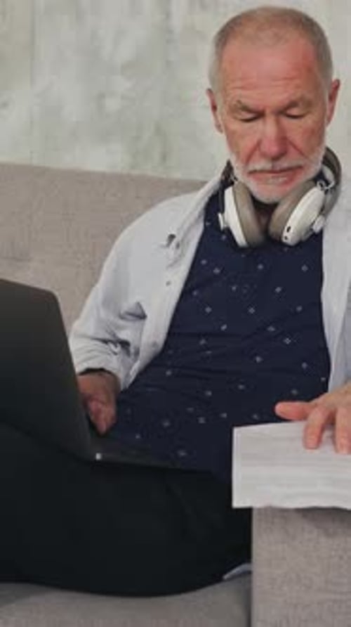 Man Working on Laptop at Home on Couch
