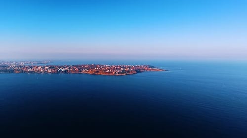 Approaching the shore of the sea or the ocean with residential area.