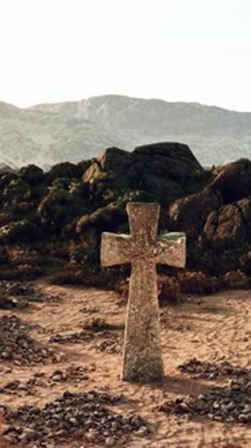 A Solitary Cross in the Vast Desert Landscape with Majestic Mountains