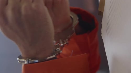 Inmate in court upset in handcuffs