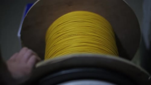 Large Spool of Yellow Wire Handled in Factory