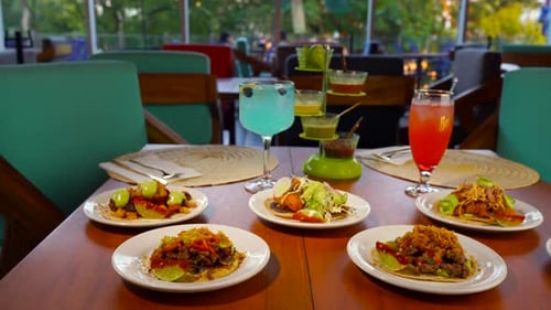 Mexican restaurant table full of tacos and cocktails