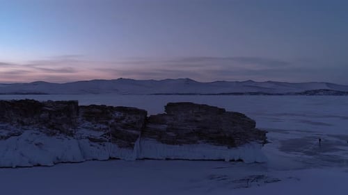 Aerial Orbital Winter Landscape of Frozen Lake Baikal Groups of Tourists Walking Around the Rocky