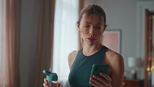 Fitness Girl Looking Smartphone After Training Home Close Up Woman Browsing