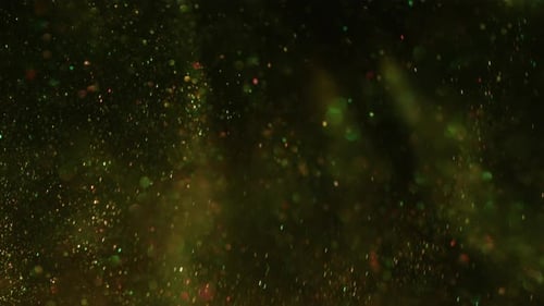 Sparkling Glitter Floating with Bokeh Effect on Dark Backdrop