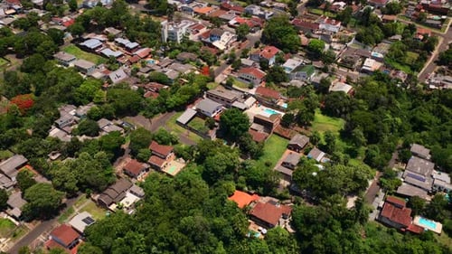 Reveal shot of Foz do Iguaçu Brazil skyline in foreground, Ciudad del Este Paraguay in the