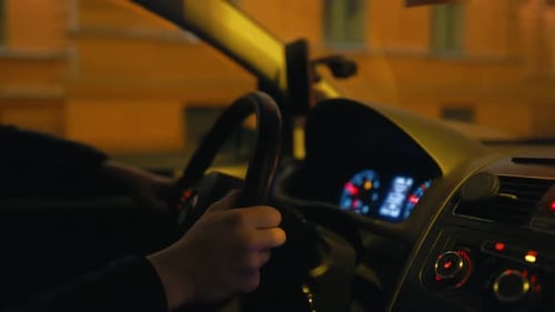 Driving at Night Person Holding Steering Wheel of Motor Vehicle
