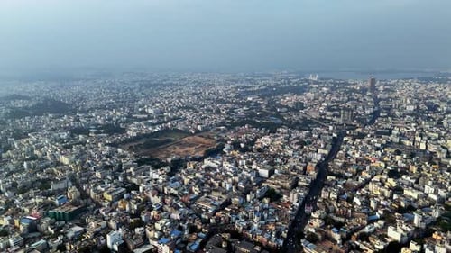 Cinematic aerial panorama of Hyderabad showcasing a vast urban expanse with dense low-rise