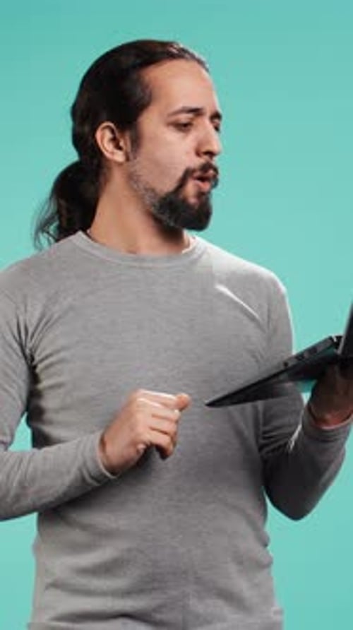 Vertical Video Man Composing Email Typing on Laptop Keyboard Excited to Log Off After Work