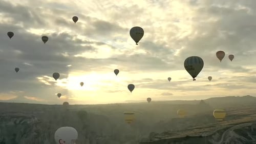 Aerial video of hot air balloons at sunrise, iconic destination behind Cappadocia Turkey
