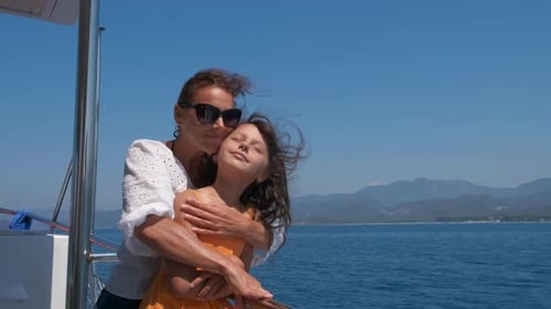 Mother and Daughter Embrace on Boat Voyage