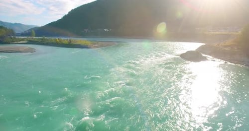Low Altitude Flight Over Fresh Fast Mountain River with Rocks at Sunny Summer Morning