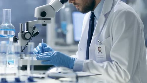Scientist Using Microscope in Bright Laboratory Setting