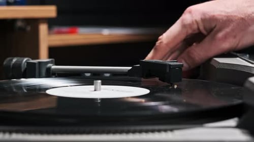 Turntable Needle Drop on a Spinning Vinyl Record to Playing Music Close Up