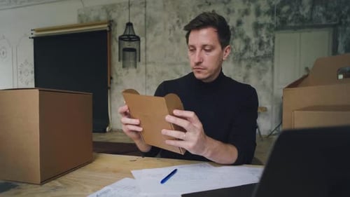 The Designer is Working He is Thinking About a New Packaging Design