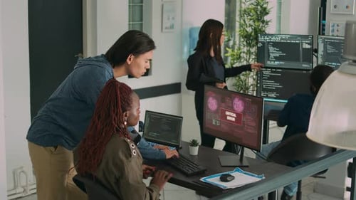 Team of Coders Fixing Critical Error in Office