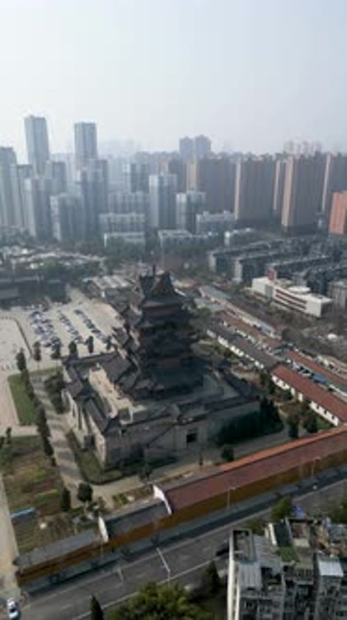 Aerial view of cityscape with high-rises and pagodas, China.