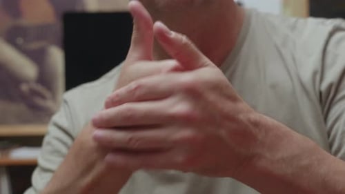 Man Cracking Knuckles Close Up Hands Showing Finger Joint Popping Gesture Detail