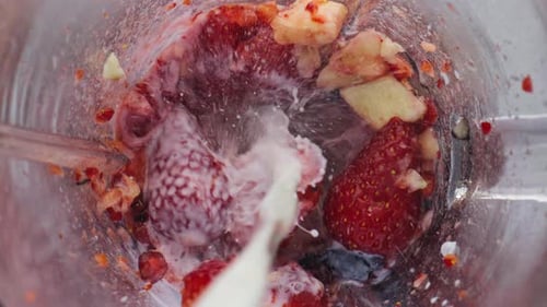 Fresh Milk Flow Blender with Berries Fruits for Making Vitamin Cocktail Close Up