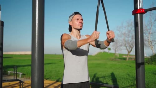 Man Exercising with Resistance Bands in Park