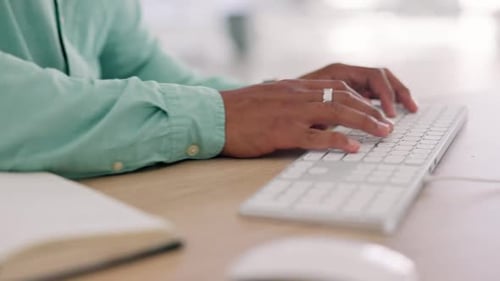 Person Writing in Notebook then Typing on Keyboard