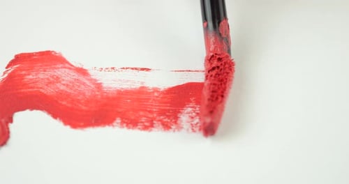Brush strokes of Cosmetic liquid lip red gloss on isolated white background.