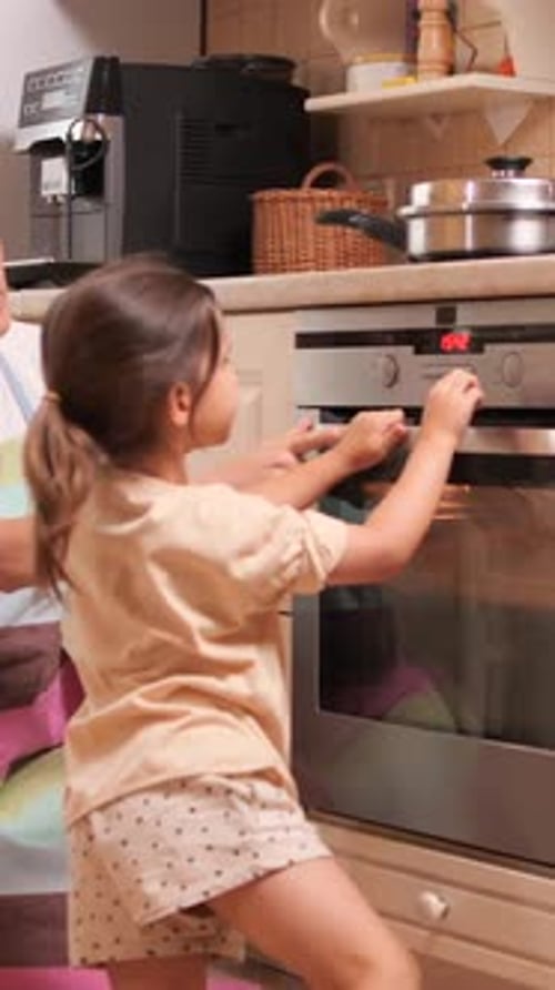 Child Helping with Oven in Home Kitchen