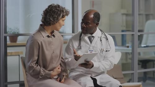 Doctor Explains Treatment Plan to Patient with Tablet