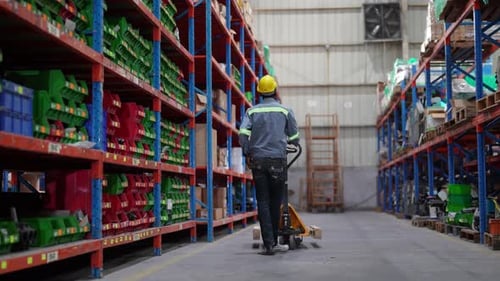 Warehouse Industrial and Logistics Companies. Dispatcher in uniform making inventory in storehouse.